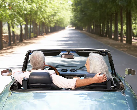 Couple driving their classic car