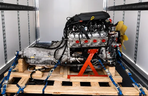 Engine and transmission secured on a pallet inside a freight trailer
